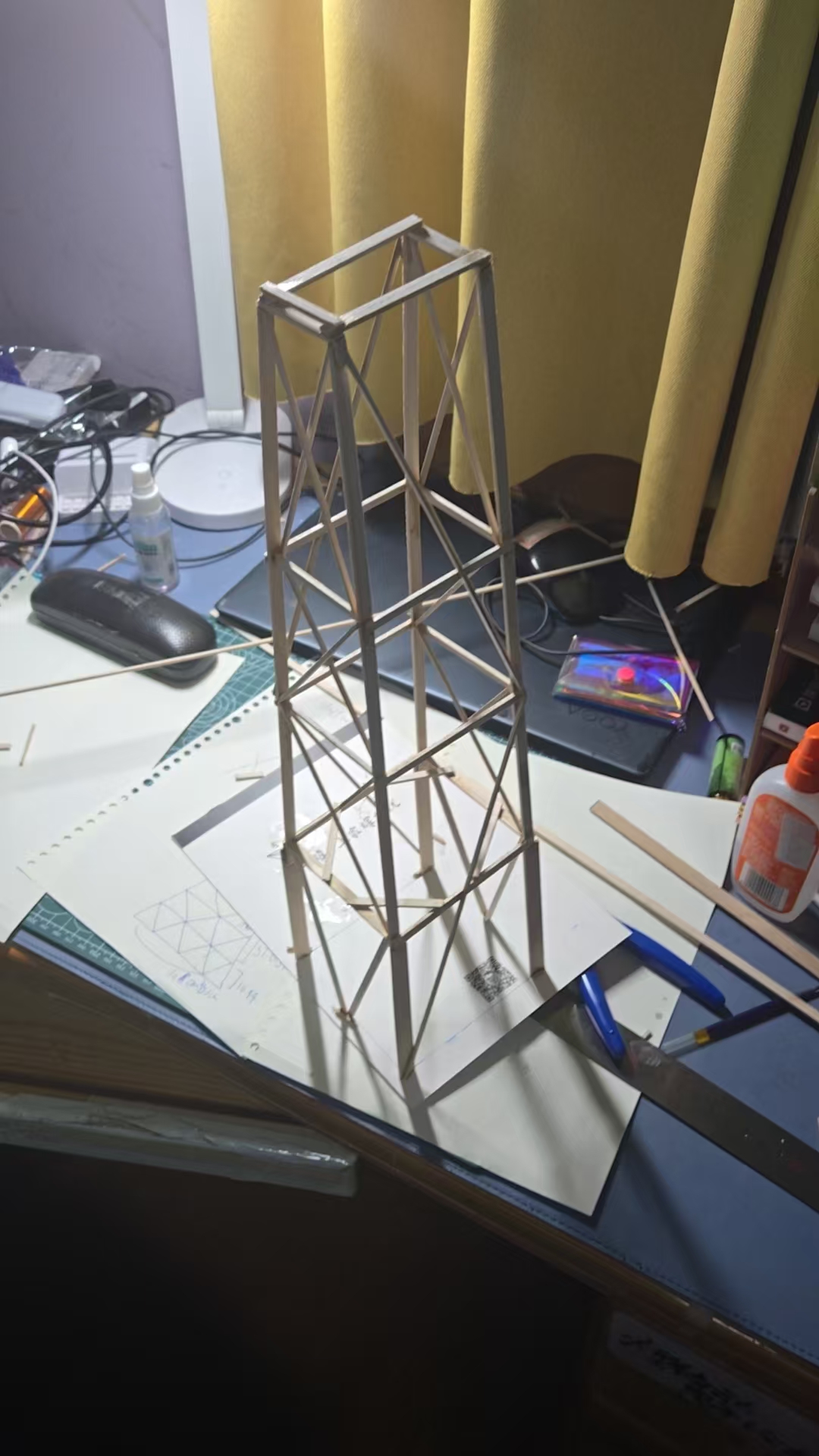 Close-up of the balsa wood structure with triangular bracing on desk